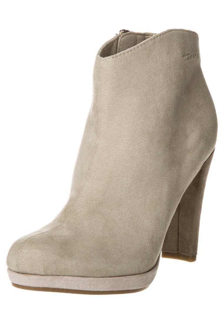 Beige suede ankle boot with a rounded toe, high heel, and a smooth finish. Features a side zipper and subtle stitching detail.