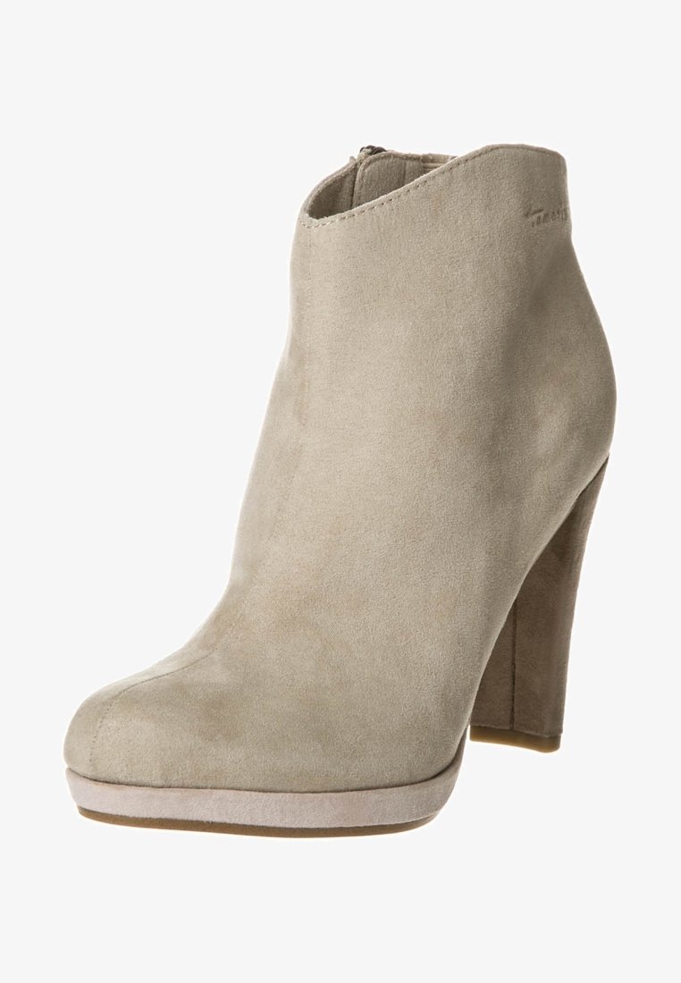 Beige suede ankle boot with a rounded toe, high heel, and a smooth finish. Features a side zipper and subtle stitching detail.
