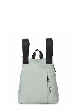 Lichtgrijze rechthoekige tas met twee brede zwarte schouderbanden, een klein handvat en een voorvak met rits met het label "KCB Vegan Bags."