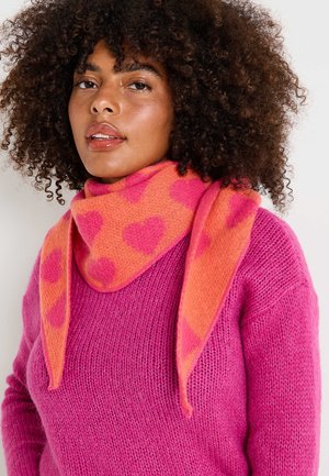 Suéter de punto rosa con acabado texturizado, combinado con una bufanda que presenta patrones de corazones en naranja y rosa. Materiales suaves y acogedores.