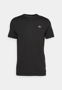 T-shirt nera a maniche corte realizzata in tessuto morbido, con un piccolo logo verde e bianco sulla parte sinistra del petto e un classico scollo rotondo.
