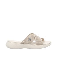 Beige slip-on sandal with cross straps, made of breathable mesh material. Soft textured sole with a patterned grip. Lightweight design.