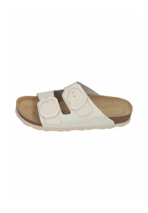 White slide sandal featuring two adjustable straps with octagonal buckles, a cork footbed, and a textured rubber sole.