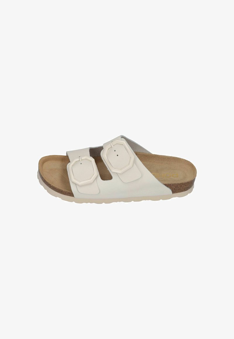 White slide sandal featuring two adjustable straps with octagonal buckles, a cork footbed, and a textured rubber sole.