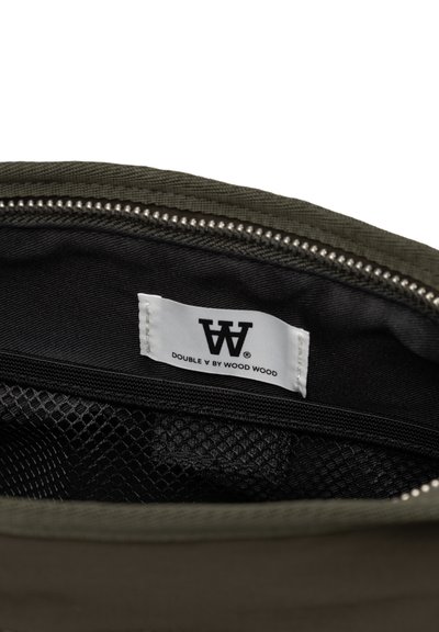 Pochette zippée olive avec un intérieur noir, dotée d'une poche en mesh et d'une étiquette blanche avec un texte noir indiquant "DOUBLE V BY WOOD WOOD."