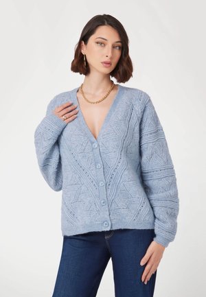 Cardigan bleu clair avec un col en V, un motif en maille texturée, des manches longues et six boutons sur le devant. Matériau doux et coupe décontractée.