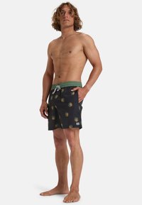 Costume da bagno neri in tessuto con cintura elastica verde. Presenta motivi circolari multicolore. Tasca laterale a sinistra.