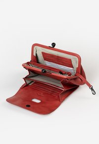Red leather wallet with multiple compartments, elastic closures, and a striped textile lining. Features card slots and a zipper pocket.