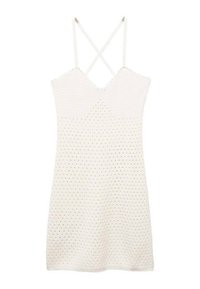 Kermaansävyinen mekko, jossa on teksturoitu neulottu kuvio, V-aukkoinen pääntie ja ristikkäiset olkaimet selässä. Lyhyt pituus, rento malli.