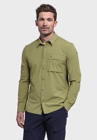 Langärmliges Shirt in olivgrün, aus glattem Stoff. Verfügt über eine Brusttasche und einen Button-Down-Kragen mit grauen Knöpfen.