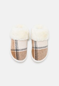 Plaid slippers with a tan and cream color scheme, featuring a soft faux fur lining and white rubber soles for comfort.
