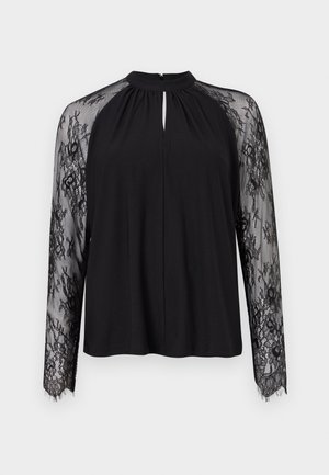 Blusa nera con scollatura a chiave e maniche lunghe in pizzo trasparente con motivi floreali. Il tessuto principale è liscio e leggero.
