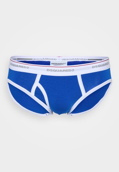 Zilā kokvilnas apakšbikses ar balto elastīgo jostasvietu. Iezīmēta ar logotipu un kontrastējošām krāsu akcentiem. Gluda tekstūra un pieguļošs dizains.