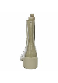Beige Leder-Ankle-Boot mit glatter Oberfläche, runder Zehenpartie und kontrastierender Gummisohle. Mit einer Anziehhilfe an der Rückseite für einfaches Anziehen.