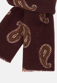 Burgundijas šalle ar paisley rakstu brūnā un krējuma krāsā, ar frēzētām malām un teksturētu audumu papildus siltumam.
