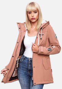 Pink hooded jacket made of soft material, featuring a zip closure, pockets, and decorative patches; worn over a white top and blue jeans.