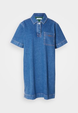 Denim polo šaty v modrej farbe s krátkymi rukávmi, gombíkovým golierom, vreckom na hrudi a kontrastným prešívaním. Hladká textúra a voľný strih.