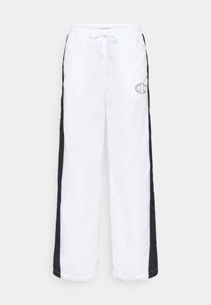 Valged sportpüksid mustade külgrihmadega. Omavad elastset vööd koos paelaga ning väikesed tikitud logod ees.