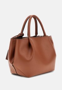 Brown leather handbag with a textured finish, structured shape, dual top handles, and subtle stitching detail at the base.