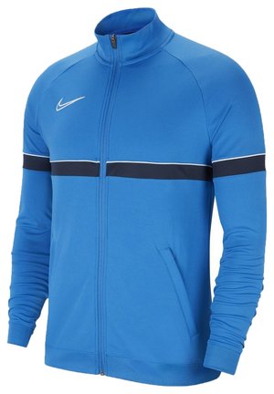 Nike Zip-Jacke in leuchtendem Blau, mit hohem Kragen, schwarzem horizontalem Streifen über der Brust und schmaler Passform mit langen Ärmeln.
