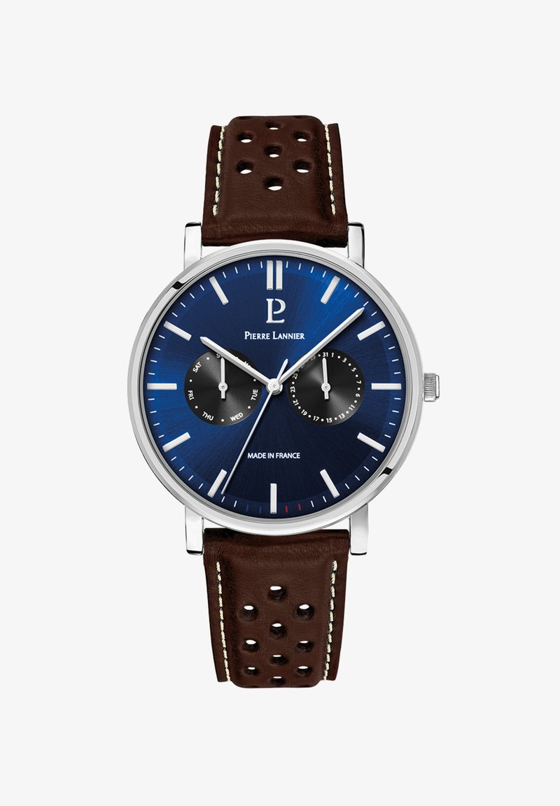 Orologio analogico con quadrante blu, cassa argentata e cinturino in pelle trapuntata marrone. Le caratteristiche includono un sottocontatore per la data e indici delle ore argentati.