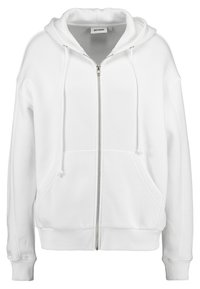 Sweat à zip blanc avec une capuche à cordon de serrage, poches kangourou, poignets et ourlet côtelés. Fabriqué dans un matériau doux avec une coupe décontractée.