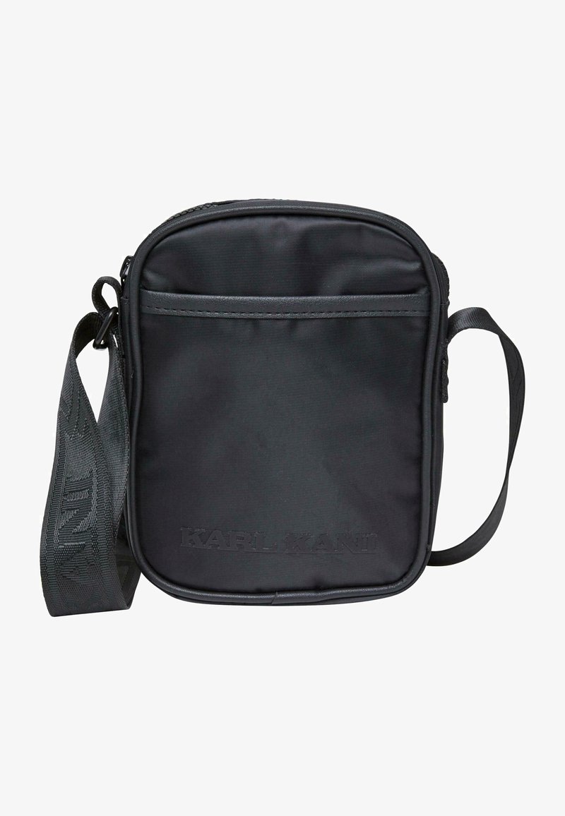 Borsa a tracolla sintetica nera con chiusura a zip, tracolla regolabile, tasca frontale, logo del marchio in rilievo e texture liscia. Design compatto.