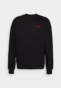 Felpa nera in cotone, con maniche lunghe, scollo rotondo e testo ricamato rosso sul petto. Design minimalista con polsini a coste.