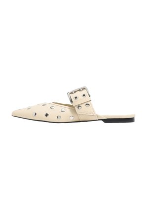 Beige leather mules with pointed toe, adorned with metallic studs, adjustable buckle strap, and flat black sole.
