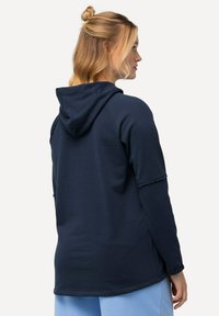 Haut à capuche bleu marine avec une capuche à cordon, des manches longues et une coupe décontractée. Texture douce, coutures minimales et sans motifs visibles.