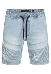 Shorts en denim bleu clair avec une taille à cordon de serrage, des détails déchirés, une texture côtelée sur les côtés et une coupe intermédiaire.