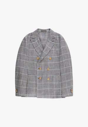 Blazer cruzado con patrón de cuadros blancos y negros y seis botones dorados, con solapas anchas y detalles de botones en los puños.