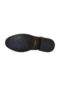 Suela de goma negra con un patrón de zigzag texturizado. Presenta una marca en relieve en el talón, proporcionando durabilidad y tracción.