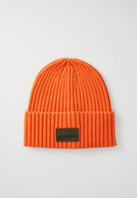 Orange ribbed knit beanie with a folded cuff. Features a black rectangular label with embossed text. Soft texture and close-fitting design.