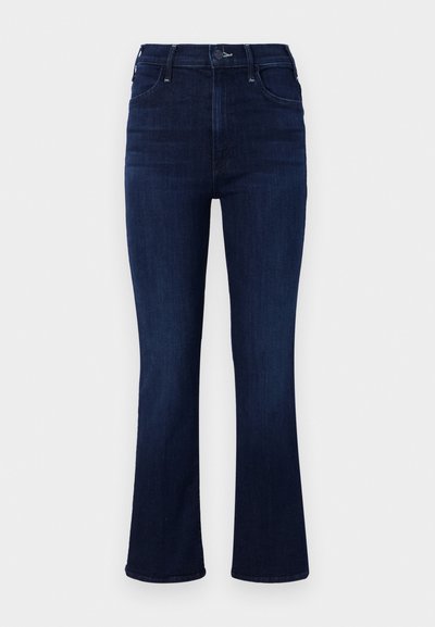 Dark wash denim flared jeans, high-waisted with five pockets, subtle stitching details, and sleek finish.