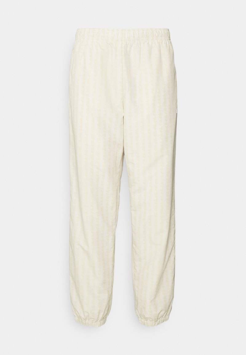 Lacoste Trainingsbroek zandkleur Lacoste Trainingsbroek zandkleur