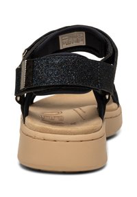 Laivatossuja, joissa on rakennekohtainen musta glitter-nauha, pehmustettu pohja ja vaaleanruskea alusta. Varustettu metalliosilla ja säädettävällä sulkimella.