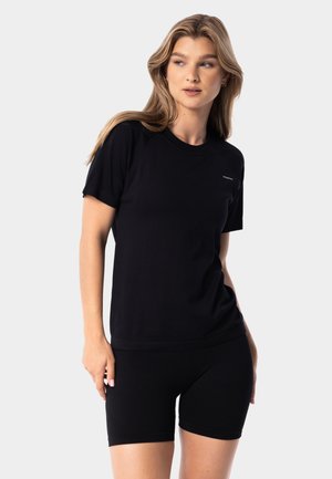 Black short-sleeve t-shirt made of soft fabric with a round neckline and a relaxed fit, paired with black shorts, featuring a simple design.