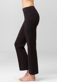 Black yoga pants with a wide waistband, straight leg design, and side pocket. Made from stretchy, smooth fabric for comfort.