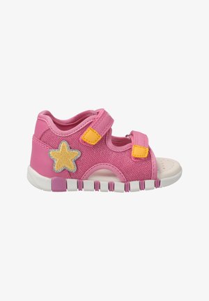 Pink mesh sandal with two yellow Velcro straps, white rubber sole, and a silver-accented yellow star detail on the side.