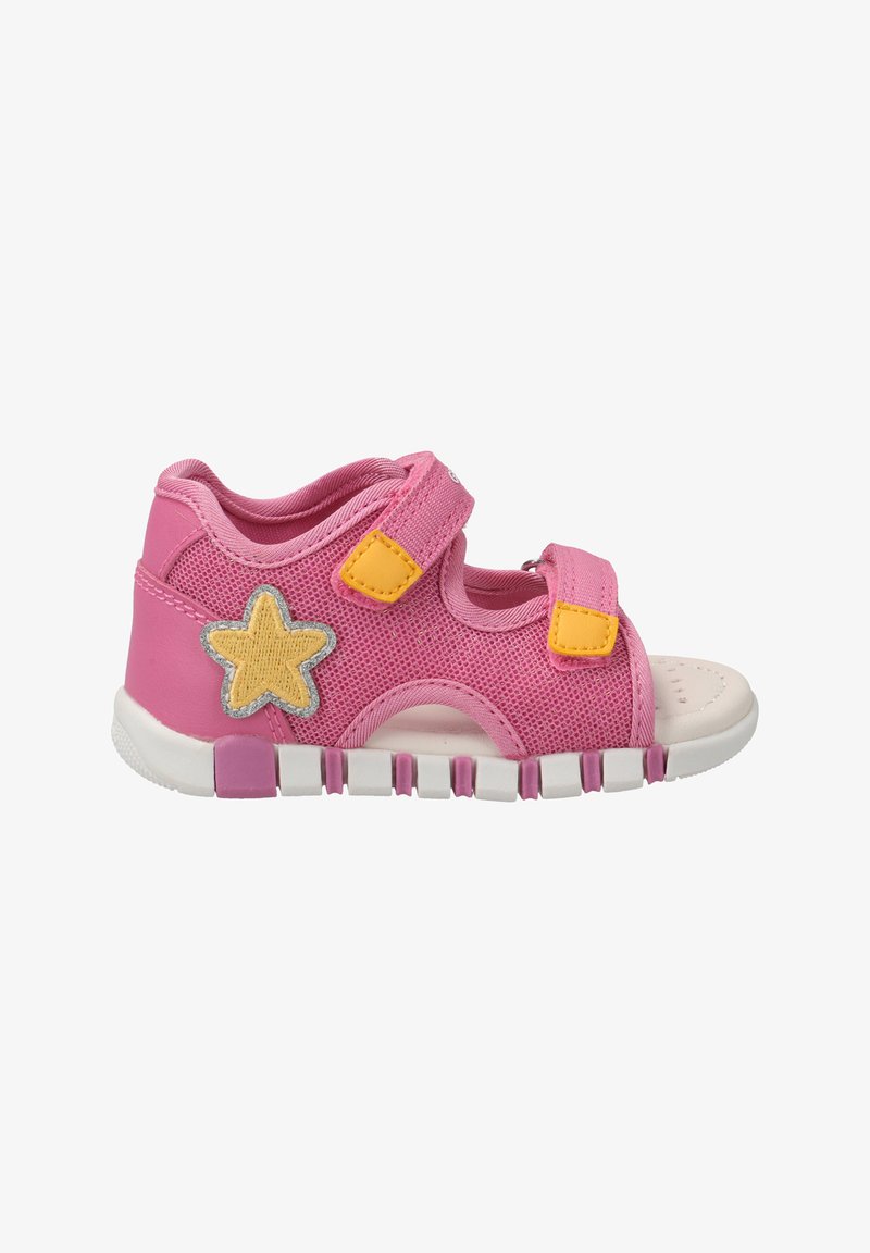 Pink mesh sandal with two yellow Velcro straps, white rubber sole, and a silver-accented yellow star detail on the side.