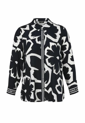 Schwarz-weißes Hemd mit langen Ärmeln und Knöpfen, verziert mit großen abstrakten Blumenmustern und Texten auf den Manschetten.