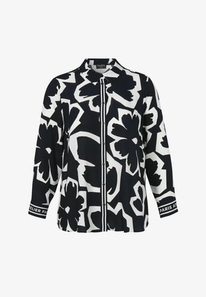 Black and white long-sleeve button-up shirt with large abstract floral patterns and text on the cuffs.