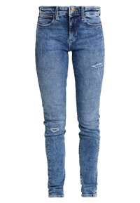 Jeans ajustados de talle alto en azul con ligero desgaste en los muslos y las rodillas, que presentan bolsillos frontales, trabillas para cinturón y un cierre con botón.