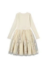 Kleto z dolgimi rokavi s kremastim, rebrastim bodijem in plastenim, prosojnim krilom, ki ima izšite nasmejane obraze na svetlo bež ozadju.