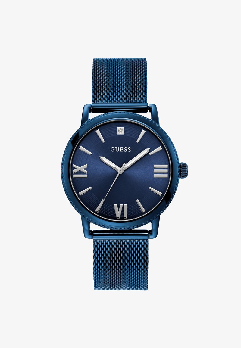 Montre en métal bleue avec un bracelet en maille, boîtier rond, cadran bleu foncé, chiffres romains argentés, et aiguilles des heures et des minutes argentées élégantes.