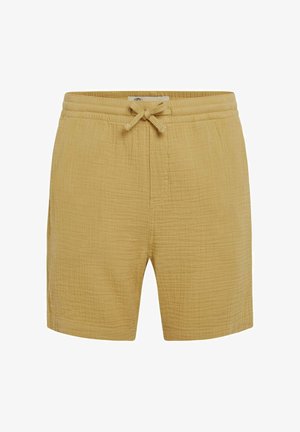 Dzelteni kokvilnas šorti ar elastīgu jostu un auklu, ar fakturētu, krunciņu audumu un sānu kabatām.