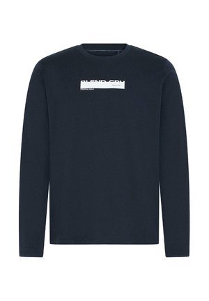 Tumesinine pika varrukaga ümar-kaelusega särk, mille rinnal on valge ristkülikukujuline logo ja tekst "BLEND CPH" ning "Original Denim Since 1993".