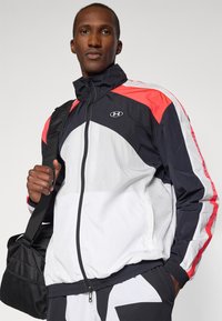Under Armour ICON TRACK - Training jacket - white/black