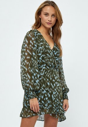 Green and blue patterned dress with long sleeves, deep V-neck, gathered waist, and ruffled hemline, made from a lightweight, sheer material.